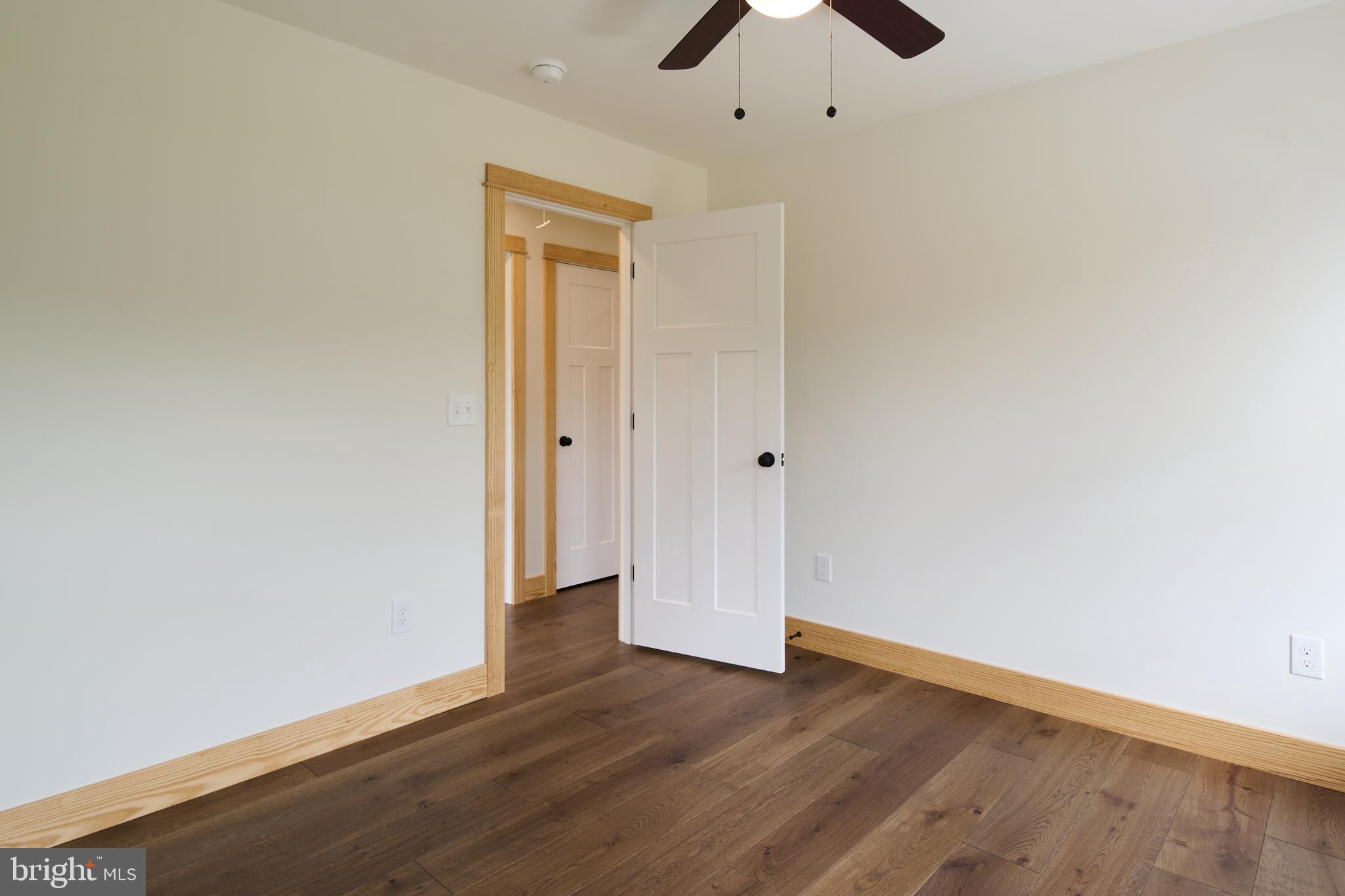 129 Lower Georges Valley Road Spring Mills, PA 16875 - Photo 31 of 61 an empty room with wooden floor and ceiling fan