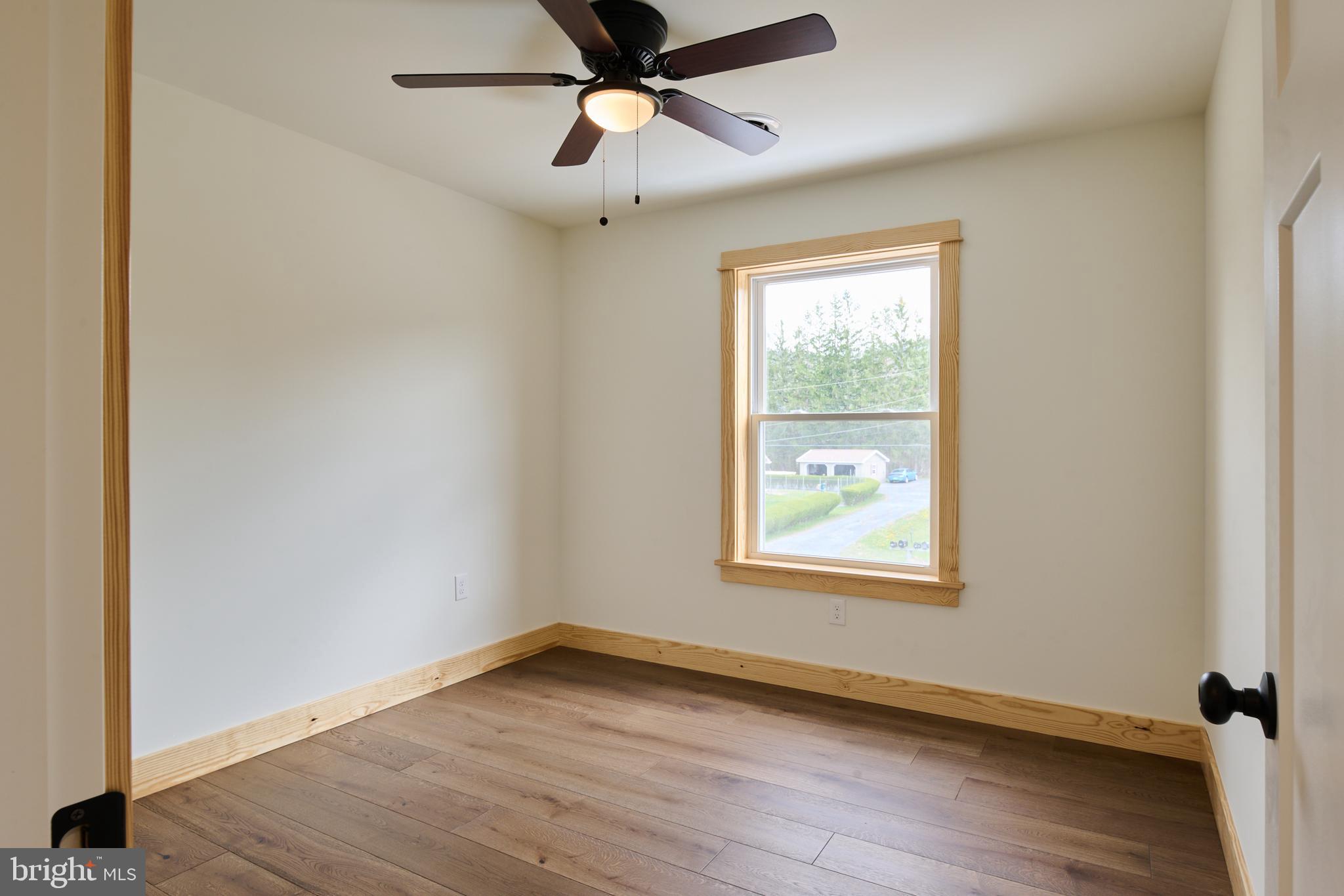 129 Lower Georges Valley Road Spring Mills, PA 16875 - Photo 33 of 61 a view of an empty room with wooden floor and a window