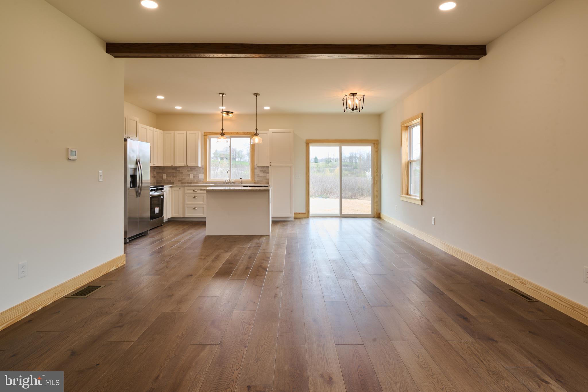 129 Lower Georges Valley Road Spring Mills, PA 16875 - Photo 4 of 61 a open kitchen with white cabinets and wooden floor