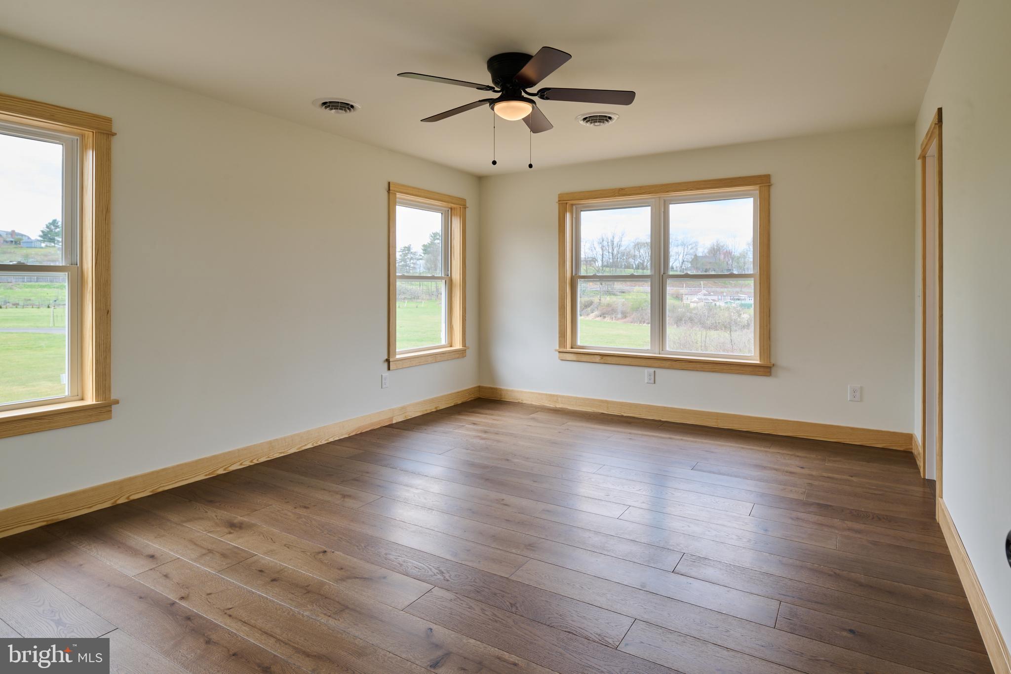 129 Lower Georges Valley Road Spring Mills, PA 16875 - Photo 41 of 61 a view of an empty room with wooden floor and a window