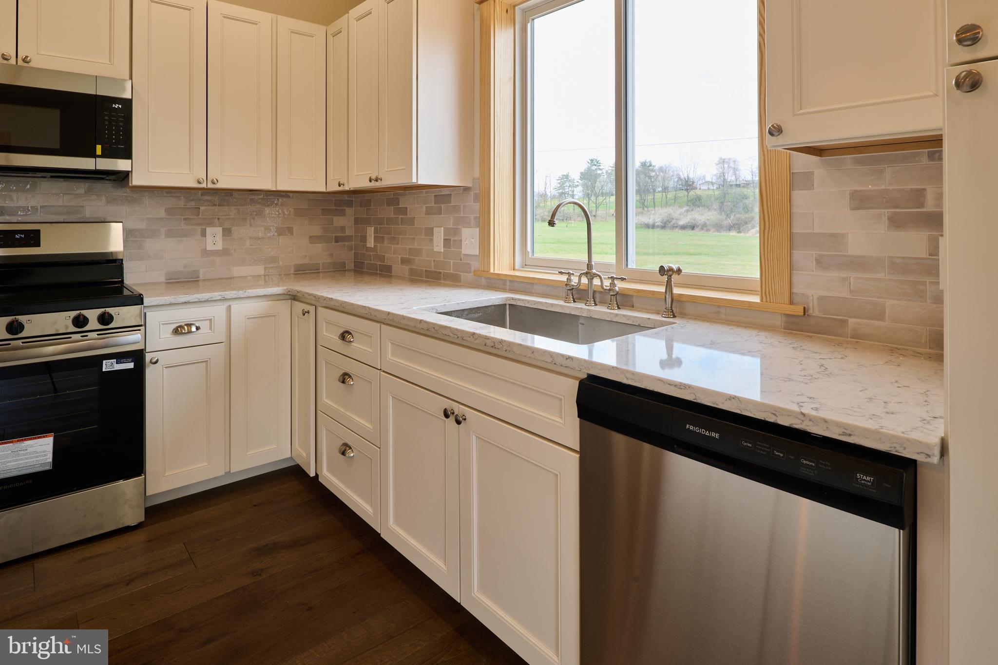 129 Lower Georges Valley Road Spring Mills, PA 16875 - Photo 8 of 61 a kitchen with a sink window and cabinets