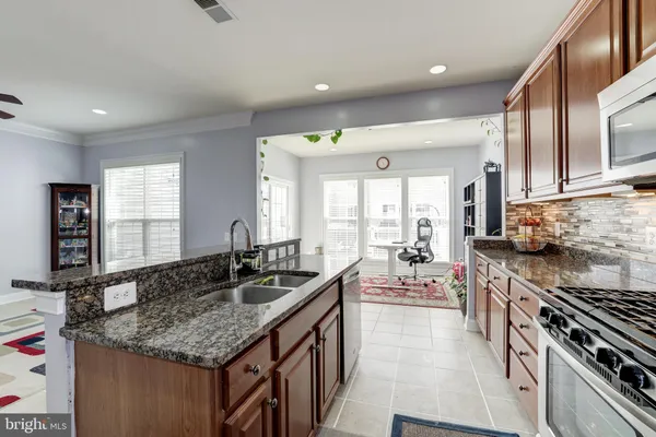 a kitchen with counter top space a sink and appliances