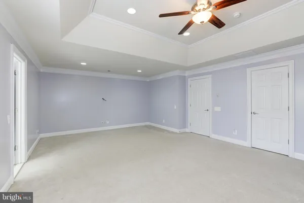 an empty room with chandelier fan