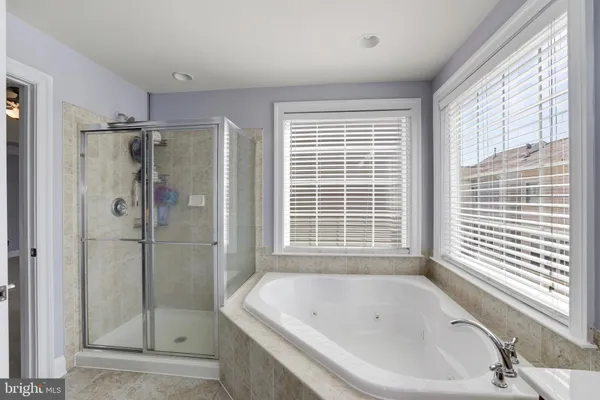 a bathroom with a bathtub and shower