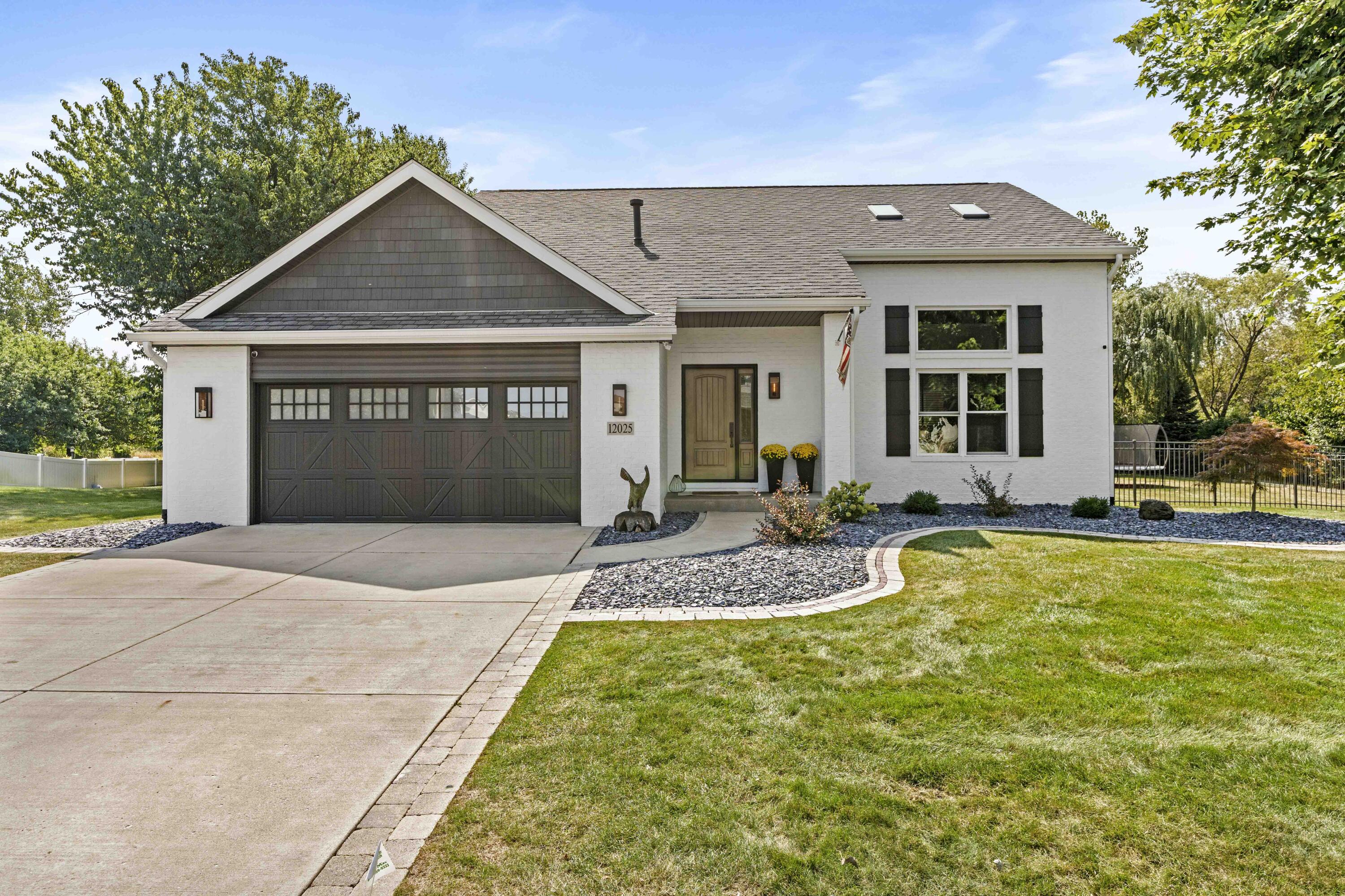 12025 Heron Lake Road St. John, IN 46373 - Photo 1 of 42 a front view of a house with a yard and garage