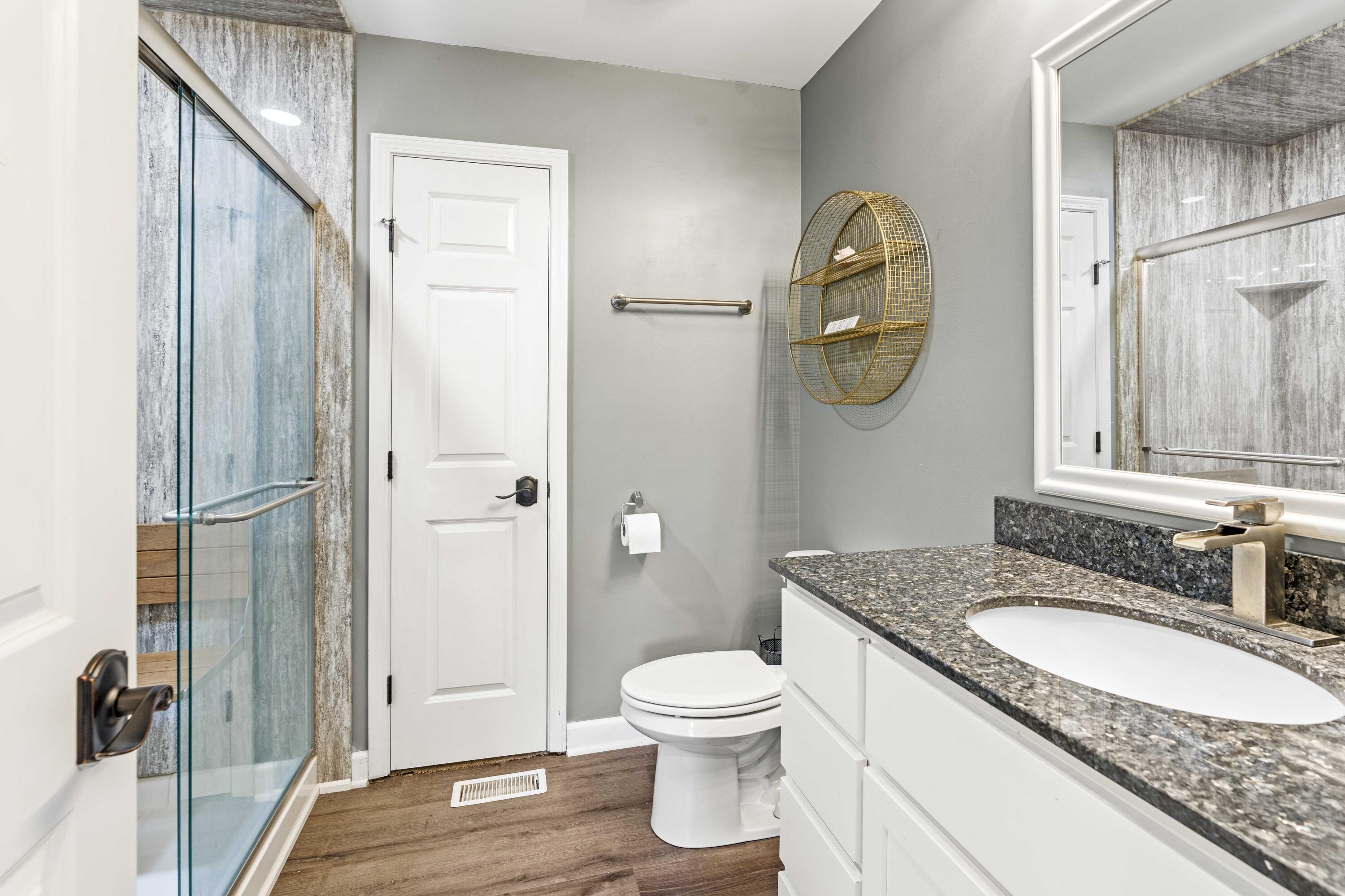 12025 Heron Lake Road St. John, IN 46373 - Photo 26 of 42 a bathroom with a granite countertop sink toilet and shower