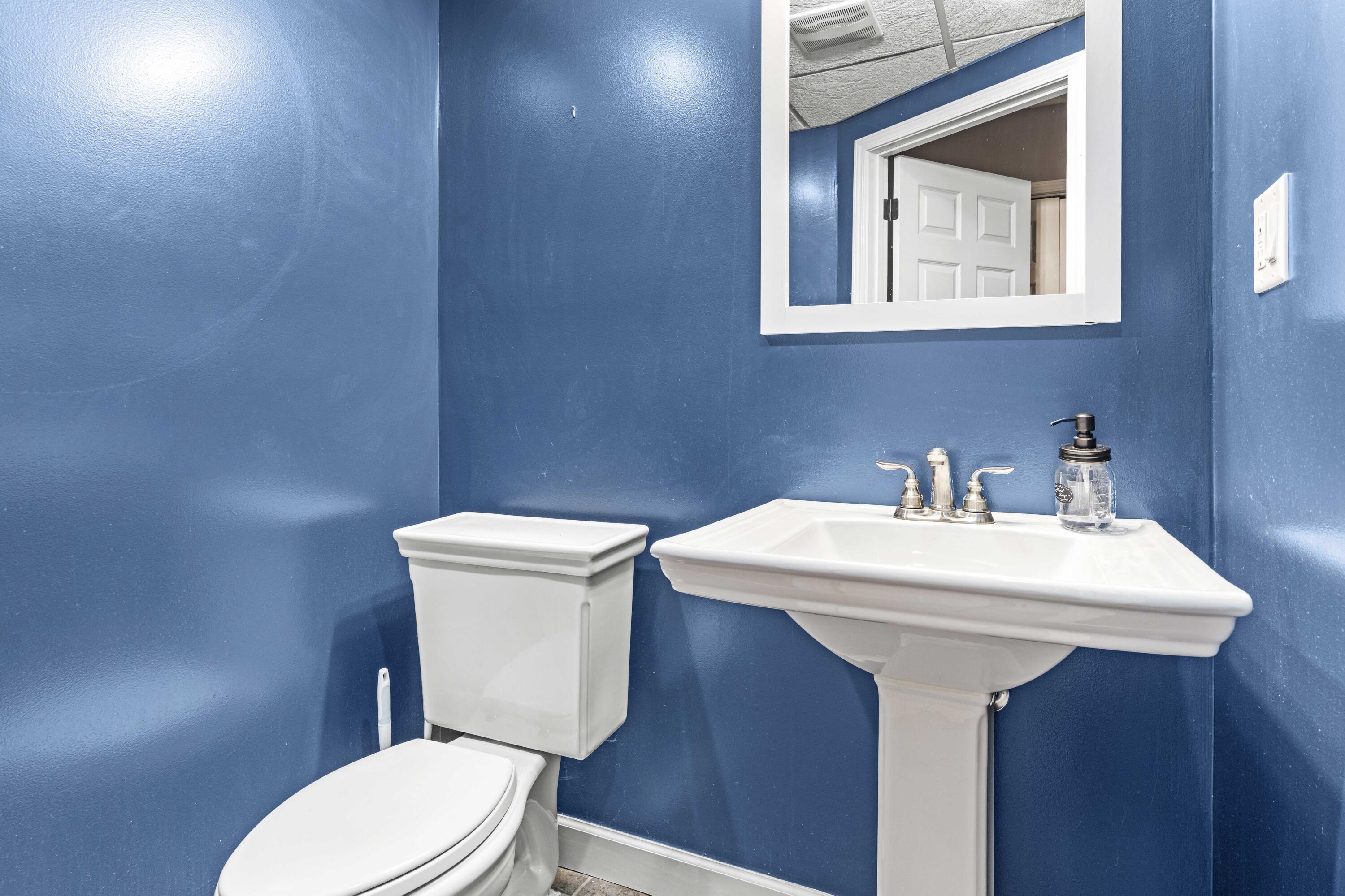 12025 Heron Lake Road St. John, IN 46373 - Photo 27 of 42 a bathroom with a toilet a sink and mirror