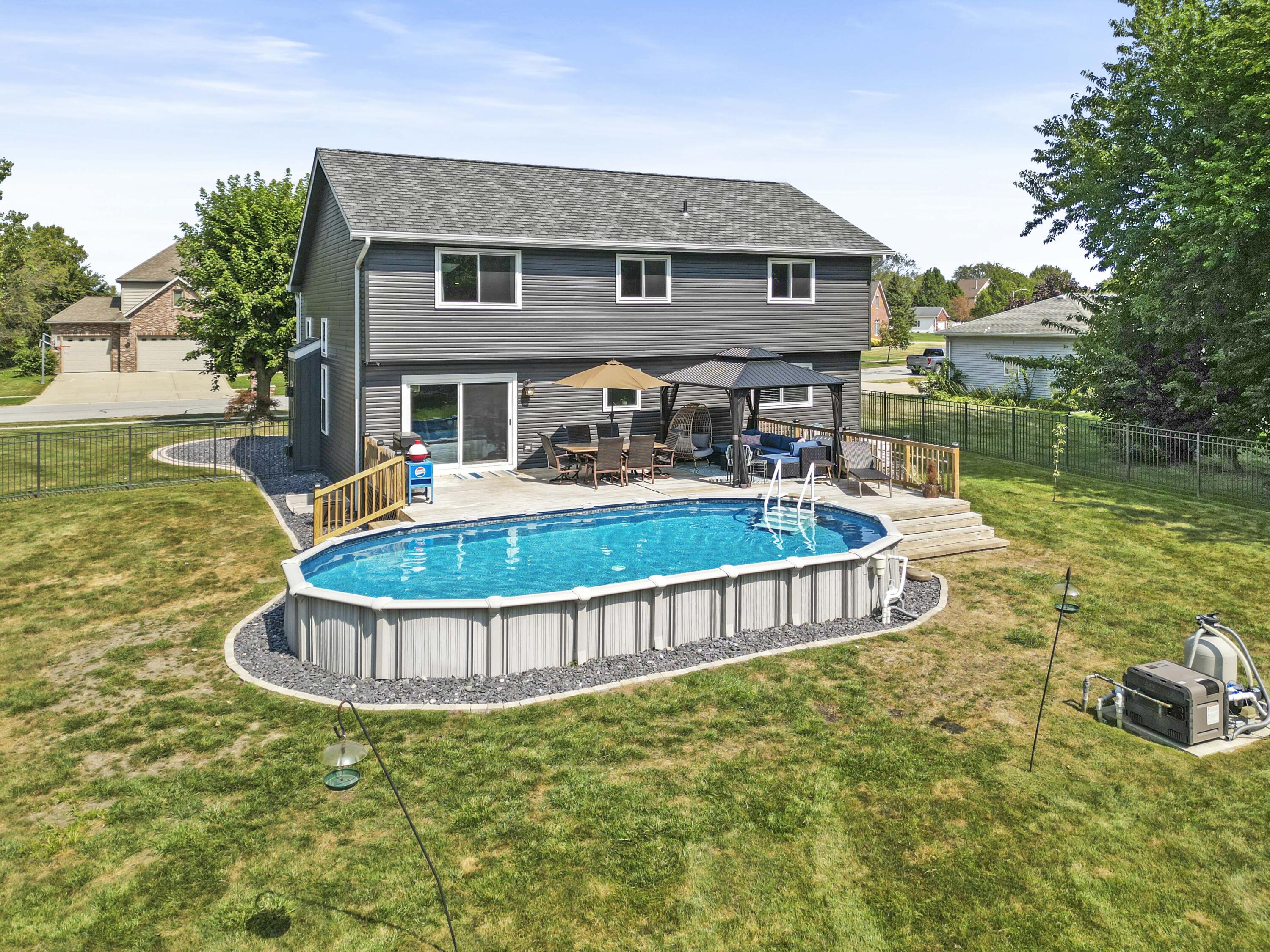 12025 Heron Lake Road St. John, IN 46373 - Photo 31 of 42 a front view of a house with swimming pool having outdoor seating