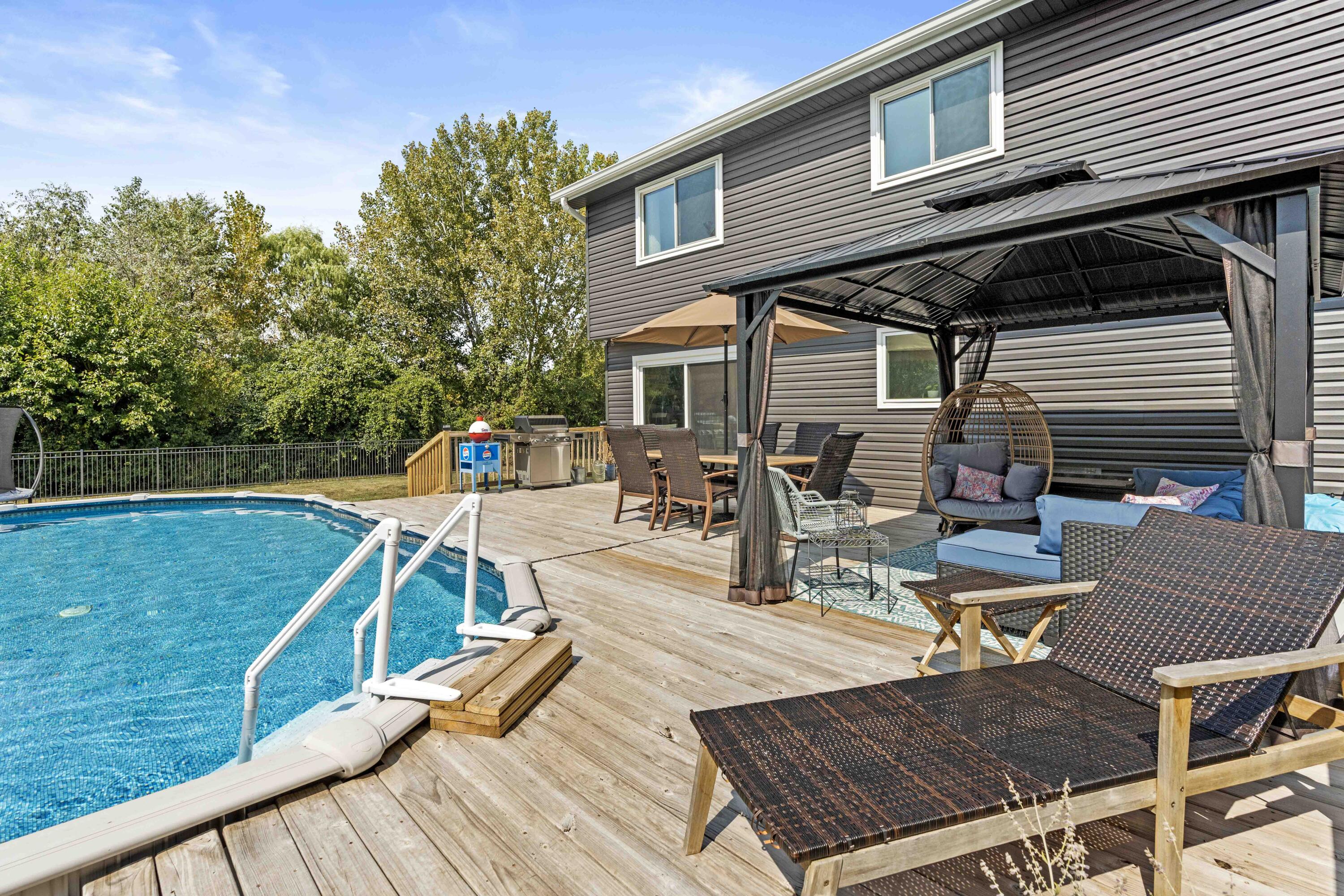 12025 Heron Lake Road St. John, IN 46373 - Photo 32 of 42 a view of a patio with table and chairs with wooden floor and fence