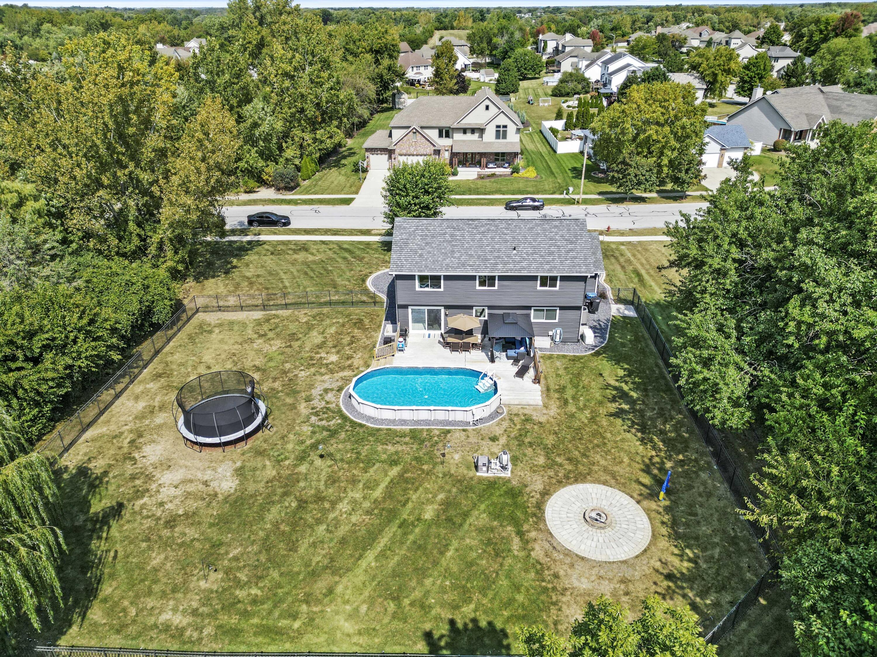 12025 Heron Lake Road St. John, IN 46373 - Photo 40 of 42 a view of a house with swimming pool and yard