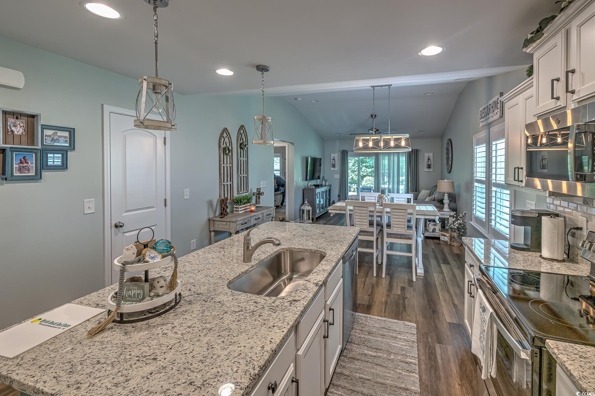 124 D Machrie Loop, Unit D Myrtle Beach, SC 29588 - Photo 7 of 37 Kitchen featuring lofted ceiling, dark hardwood /