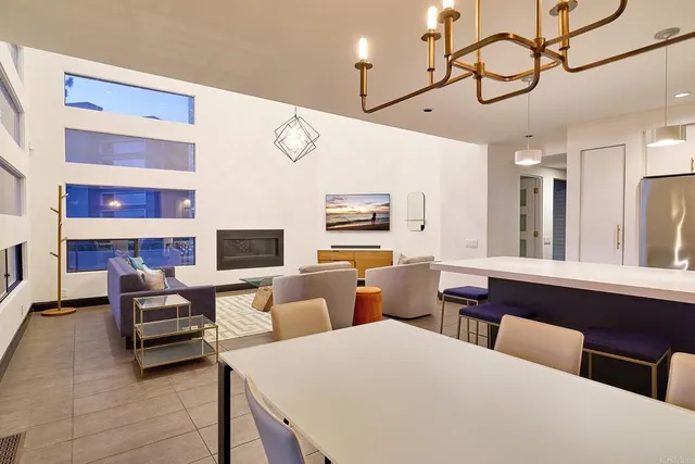 a living room with furniture a flat screen tv and kitchen view