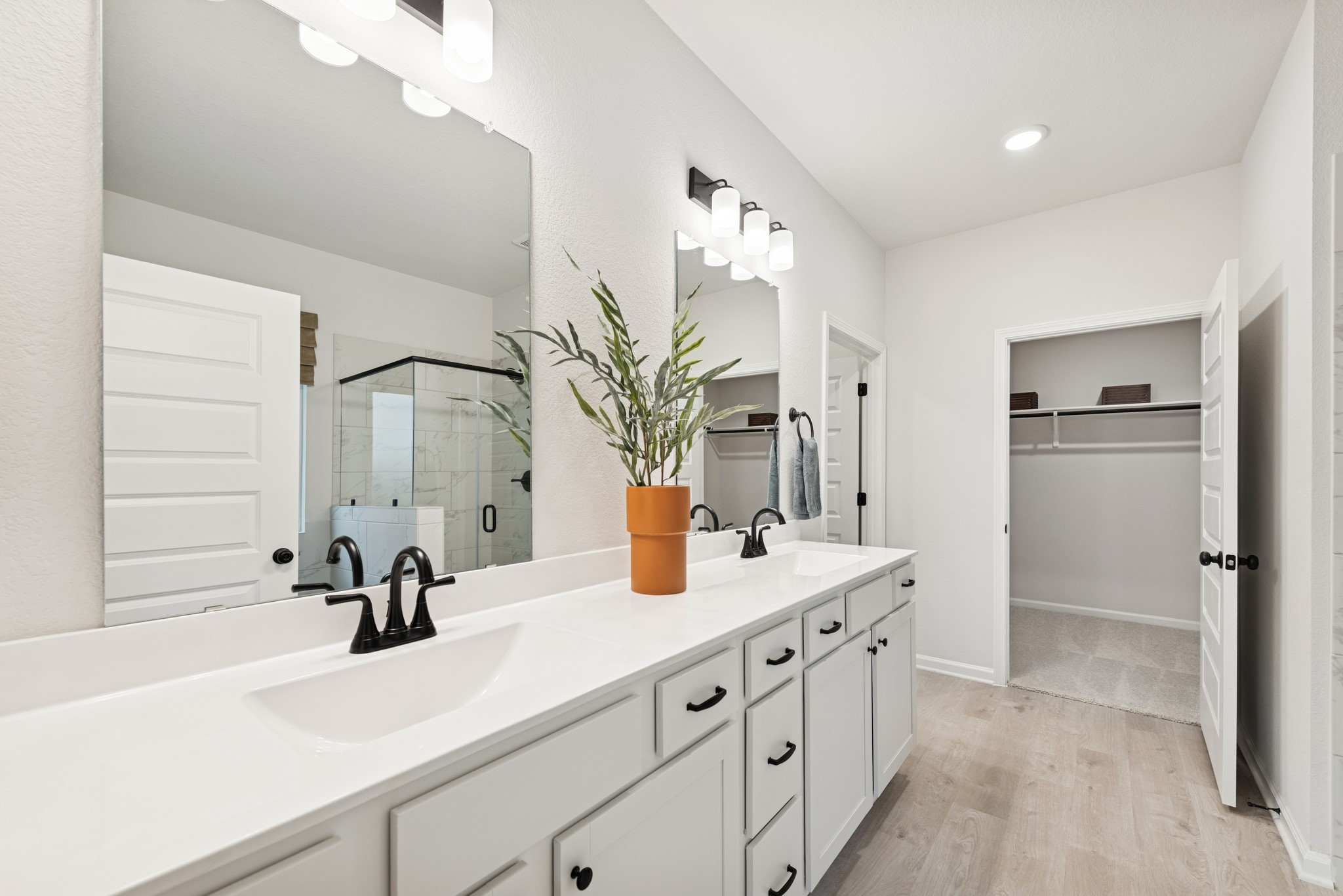 9726 Enclave Ridge Road Willis, TX 77318 - Photo 12 of 25 a bathroom with a double vanity sink a mirror and shower