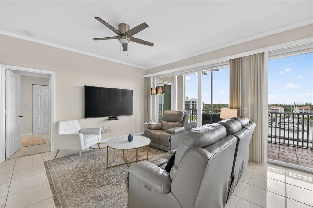 2060 Matecumbe Key Road, Unit 2506 Punta Gorda, FL 33955 - Photo 8 of 38 a living room with furniture a flat screen tv and a large window
