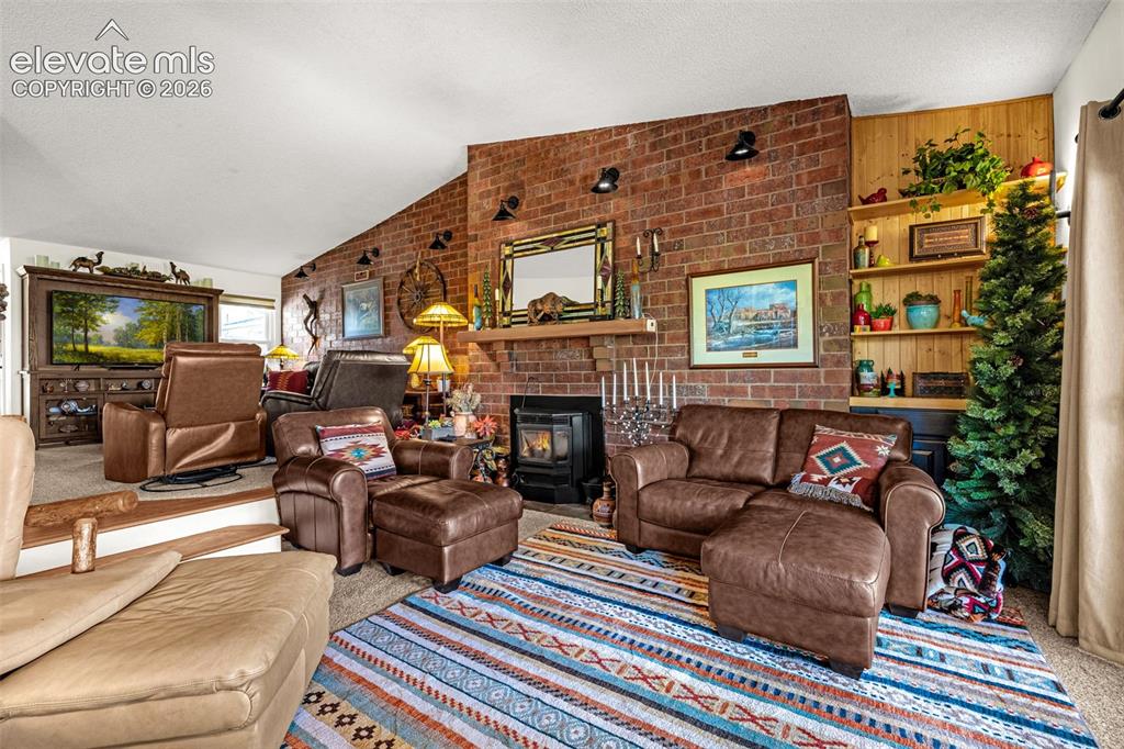 1658 Deer Creek Road Monument, CO 80132 - Photo 8 of 21 Vaulted ceilings and a cozy pellet stove welcome you to the sunken family room