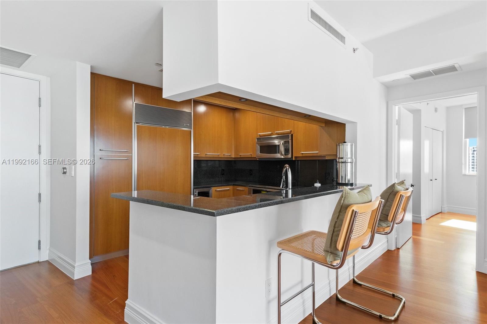 901 Brickell Key Boulevard, Unit 1609 Miami, FL 33131 - Photo 11 of 35 a living room with furniture and a flat screen tv