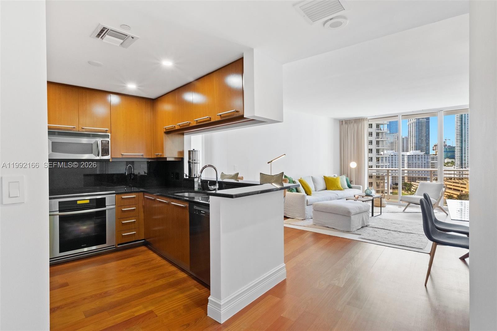 901 Brickell Key Boulevard, Unit 1609 Miami, FL 33131 - Photo 2 of 35 a kitchen with a sink appliances and cabinets