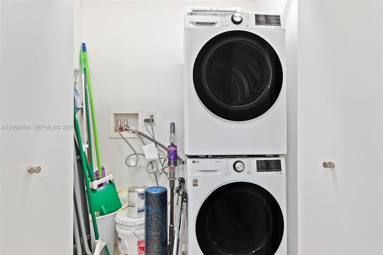 901 Brickell Key Boulevard, Unit 1609 Miami, FL 33131 - Photo 25 of 35 a view of a hallway with washer and dryer