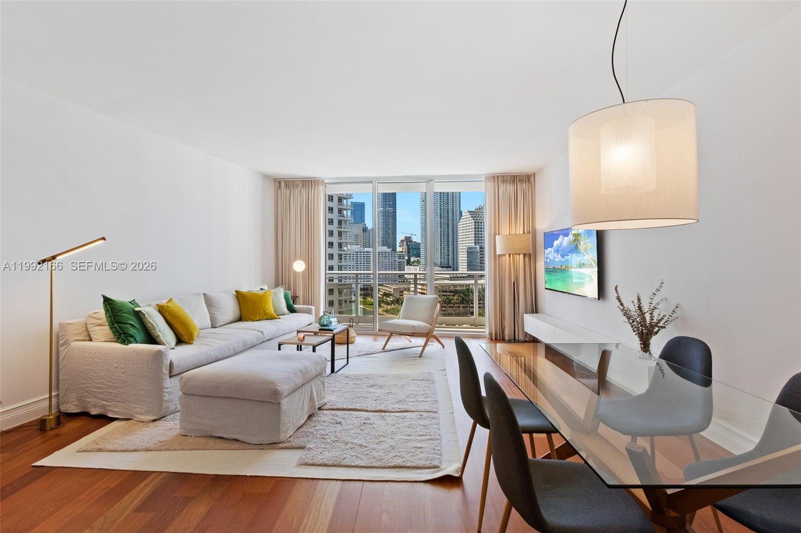 901 Brickell Key Boulevard, Unit 1609 Miami, FL 33131 - Photo 3 of 35 a living room with furniture and a table
