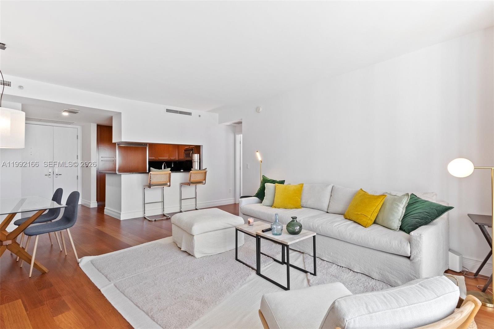 901 Brickell Key Boulevard, Unit 1609 Miami, FL 33131 - Photo 8 of 35 a living room with furniture and a flat screen tv