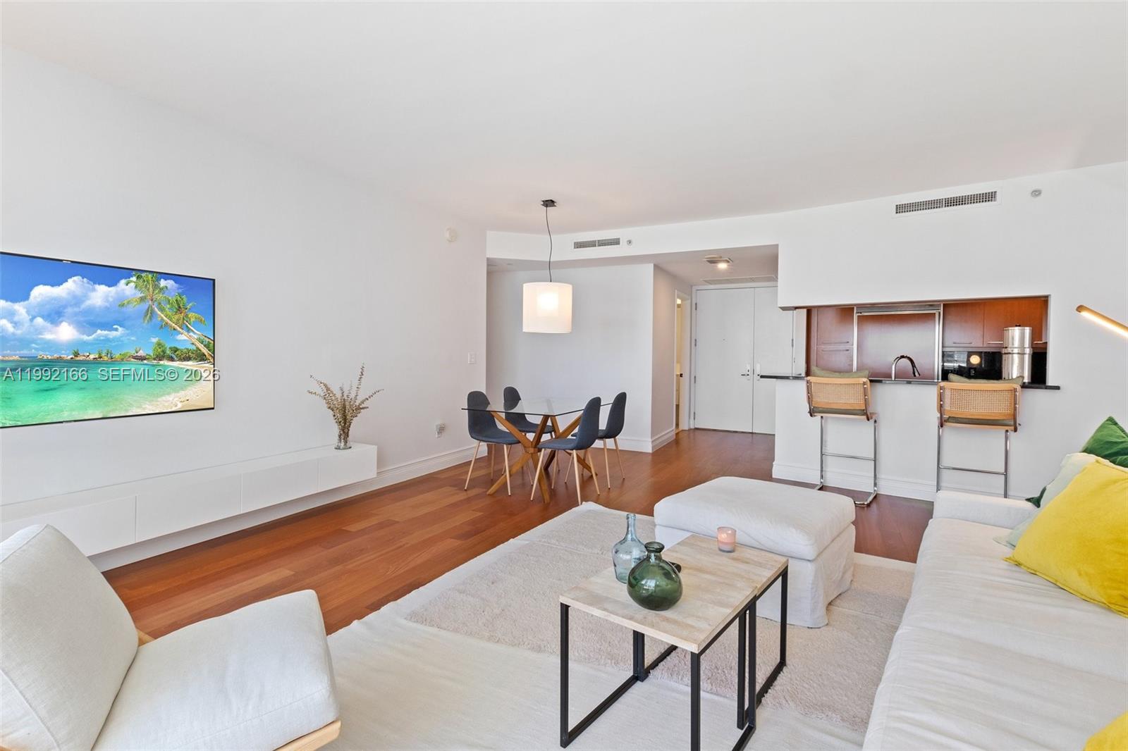 901 Brickell Key Boulevard, Unit 1609 Miami, FL 33131 - Photo 9 of 35 a living room with furniture and a flat screen tv