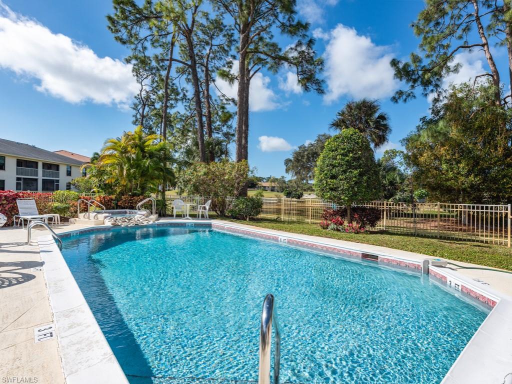 709 Augusta Boulevard, Unit 7095 Naples, FL 34113 - Photo 16 of 16 a view of swimming pool with chairs