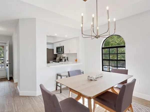 a dining room with furniture a window and wooden floor