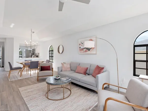 a living room with furniture a rug and a chandelier