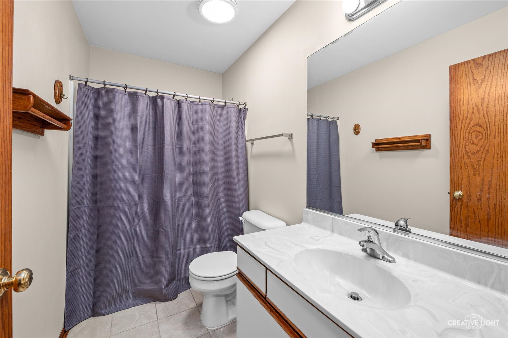 1348 Amaranth Drive Naperville, IL 60564 - Photo 17 of 34 a bathroom with a sink a toilet a mirror and shower curtain