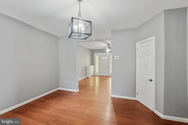 a view of empty room with wooden floor and window