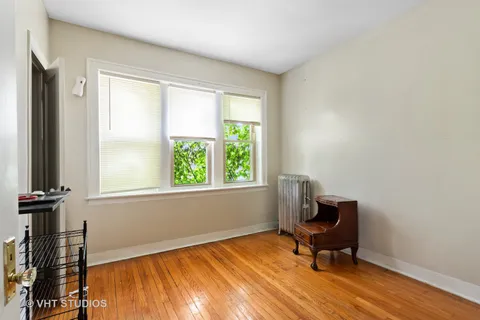 a view of a livingroom with wooden floor and a window