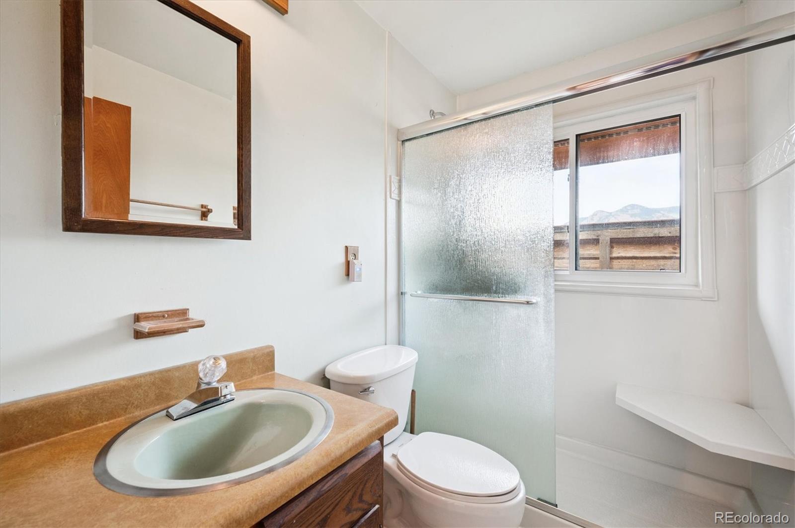 33623 Freda Road Pine, CO 80470 - Photo 16 of 27 a bathroom with a sink a mirror and a toilet