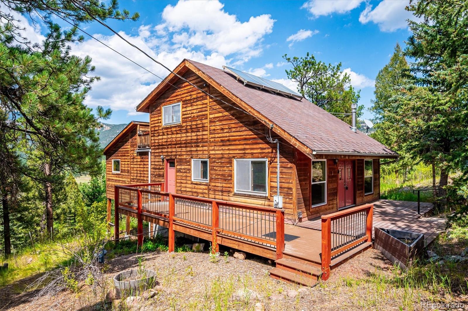 33623 Freda Road Pine, CO 80470 - Photo 18 of 27 a view of a house with a yard and wooden fence