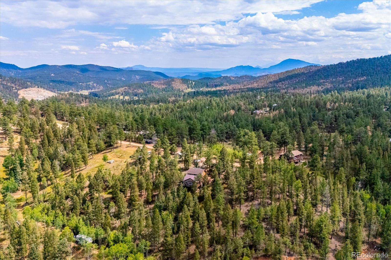 33623 Freda Road Pine, CO 80470 - Photo 26 of 27 a view of a town with mountains in the background