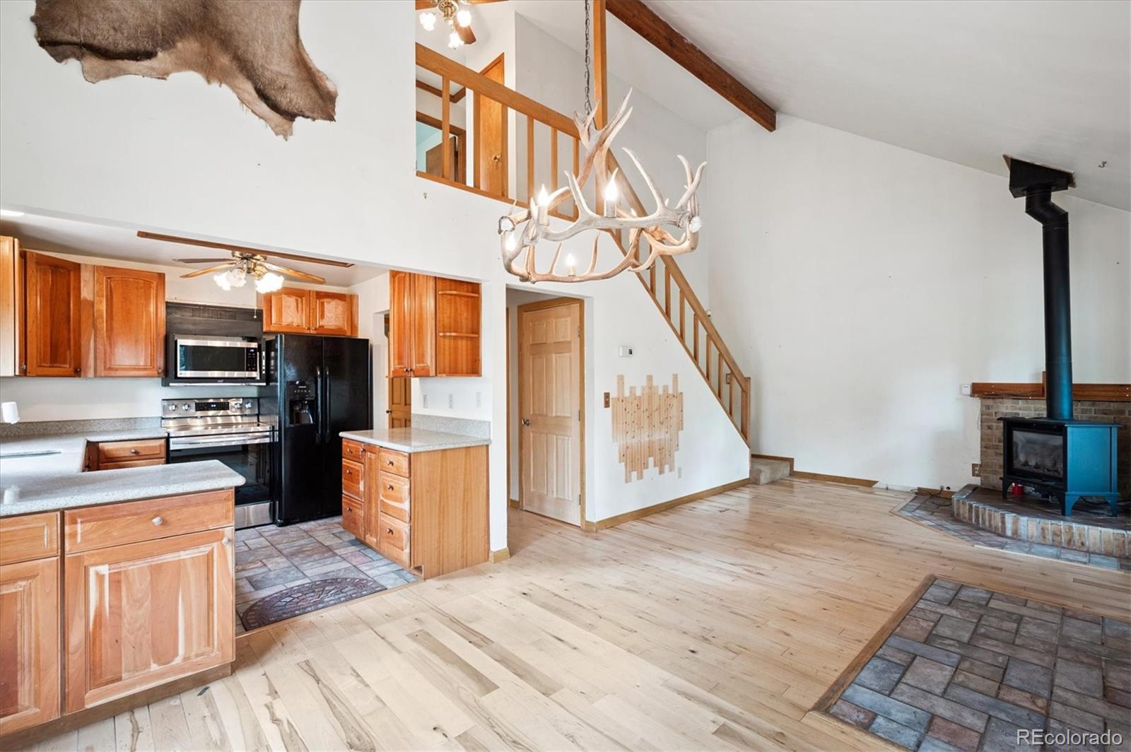 33623 Freda Road Pine, CO 80470 - Photo 4 of 27 a view of a kitchen with cabinets and wooden floor