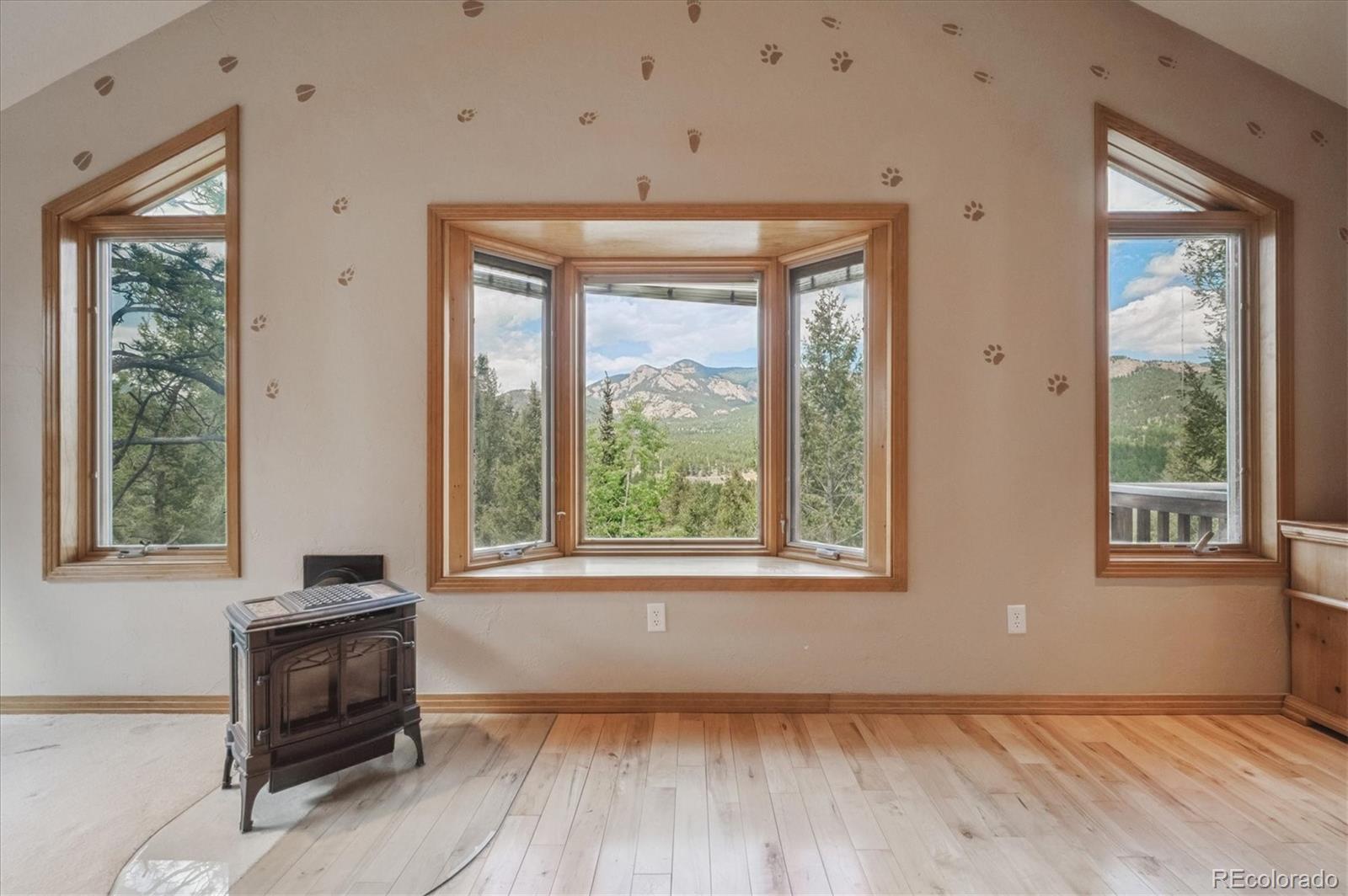 33623 Freda Road Pine, CO 80470 - Photo 7 of 27 a view of an empty room with a window and wooden floor