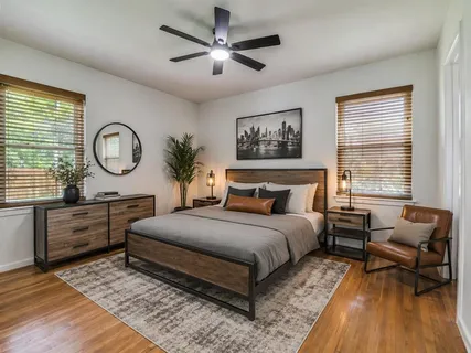 a bedroom with a large bed and a chandelier
