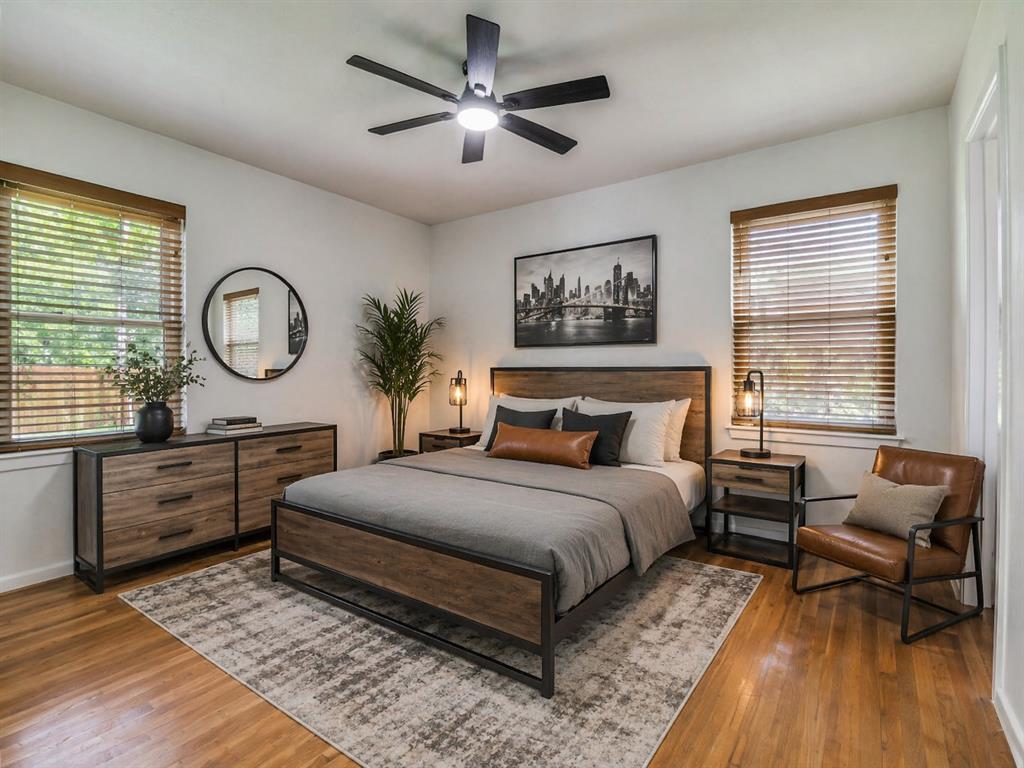 2315 Inadale Avenue Dallas, TX 75228 - Photo 21 of 36 a bedroom with a large bed and a chandelier