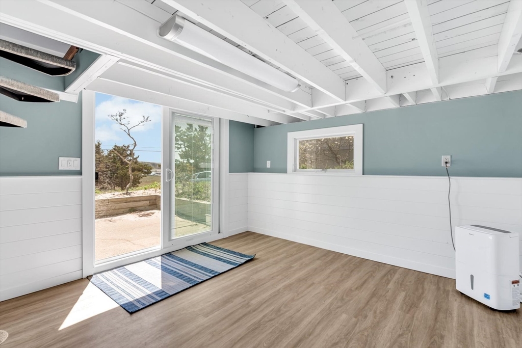 90 Salt Marsh Road East Sandwich, MA 02537 - Photo 37 of 40 a view of an empty room with wooden floor and a window