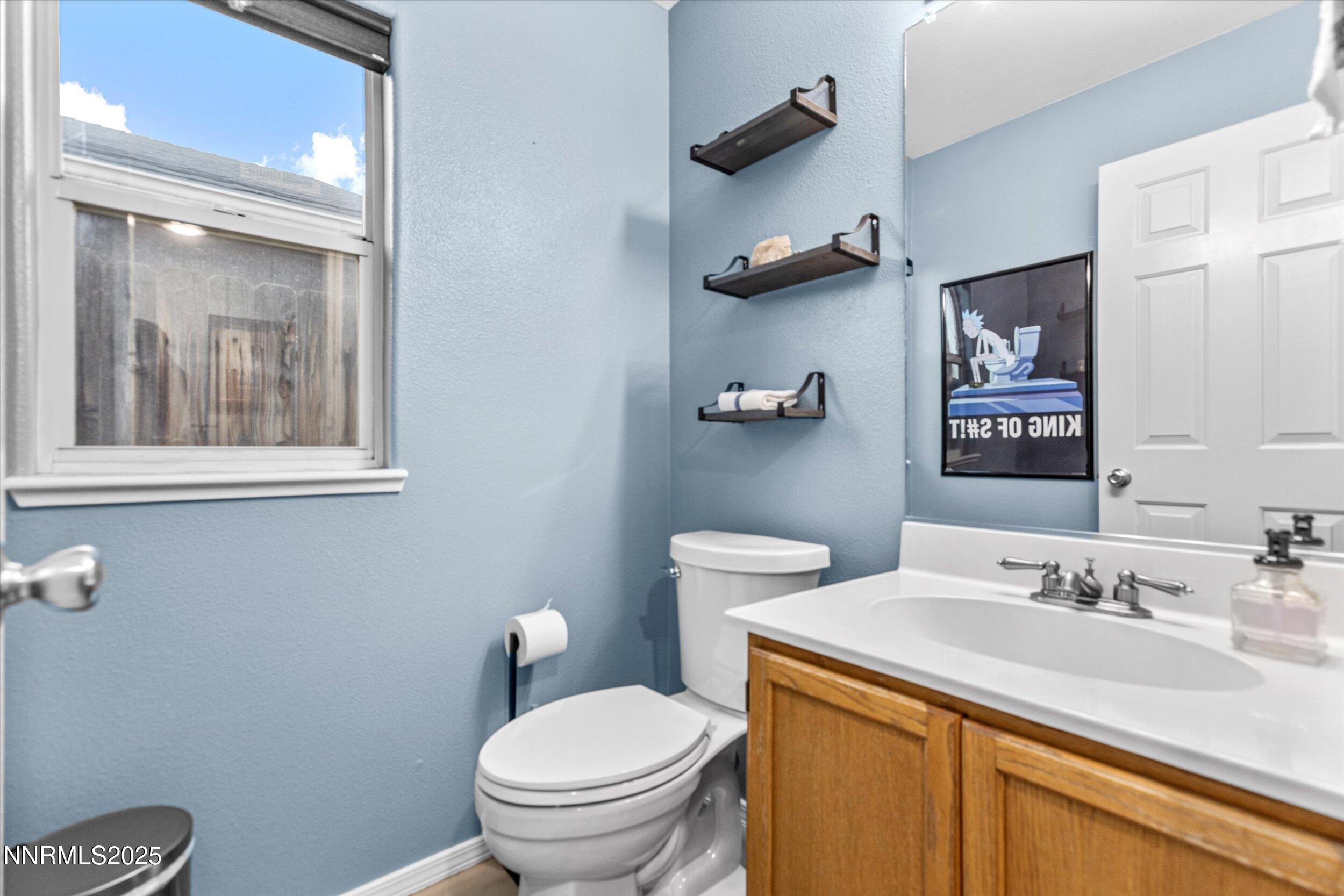 3131 Winter Rose Circle Reno, NV 89502 - Photo 13 of 32 a bathroom with a sink a toilet and mirror