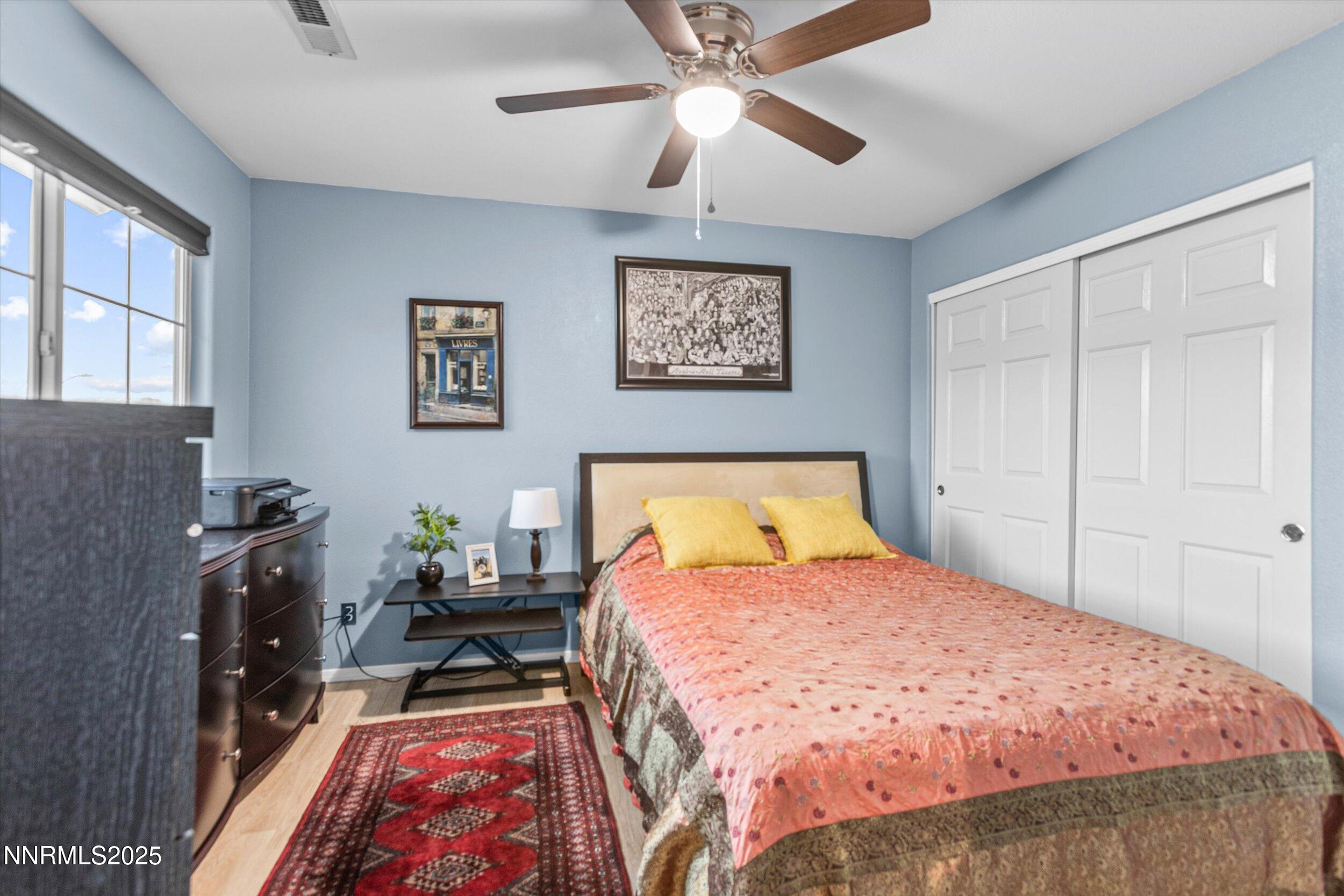 3131 Winter Rose Circle Reno, NV 89502 - Photo 16 of 32 a bedroom with a bed and a chandelier