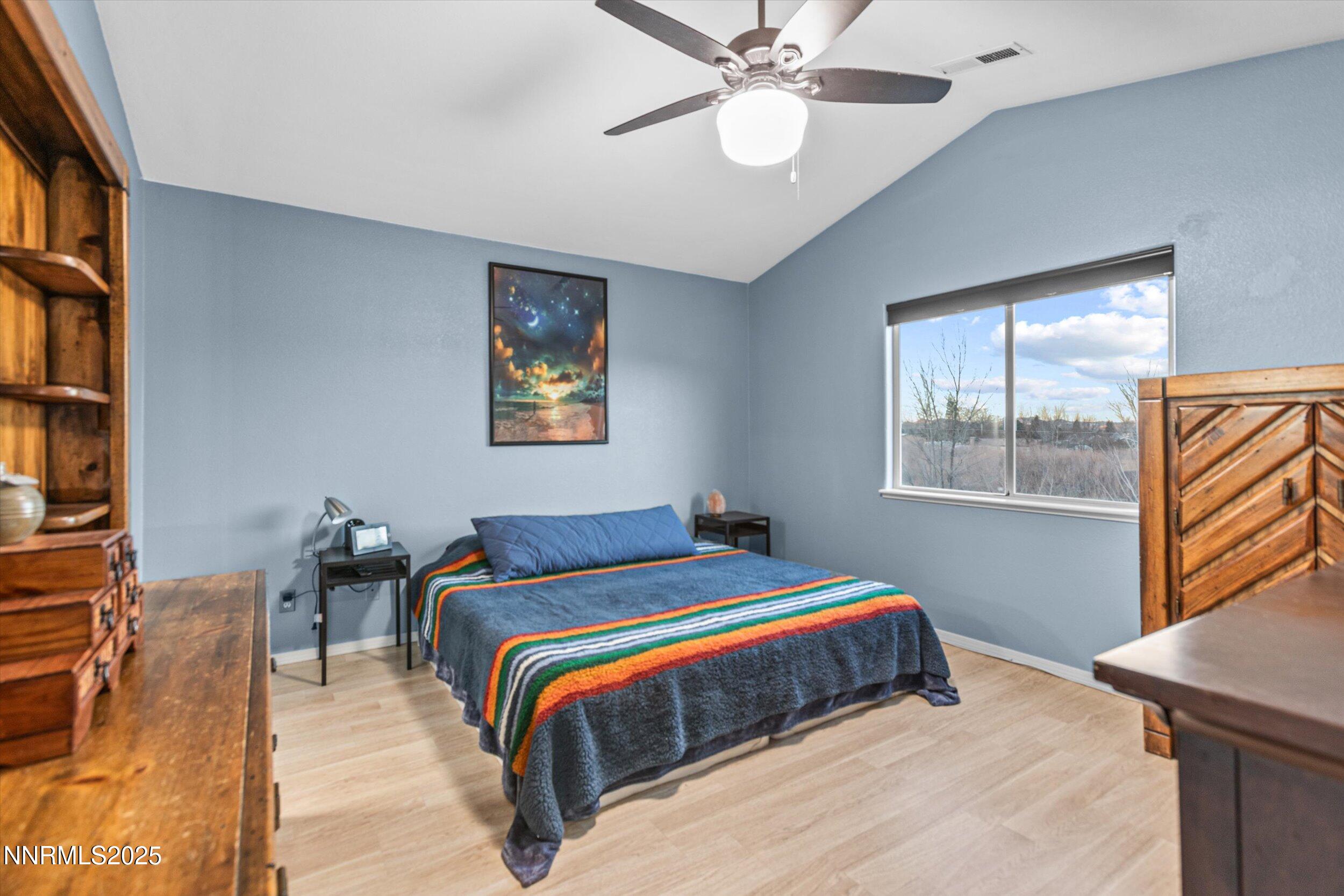 3131 Winter Rose Circle Reno, NV 89502 - Photo 17 of 32 a bedroom with a bed and a chandelier