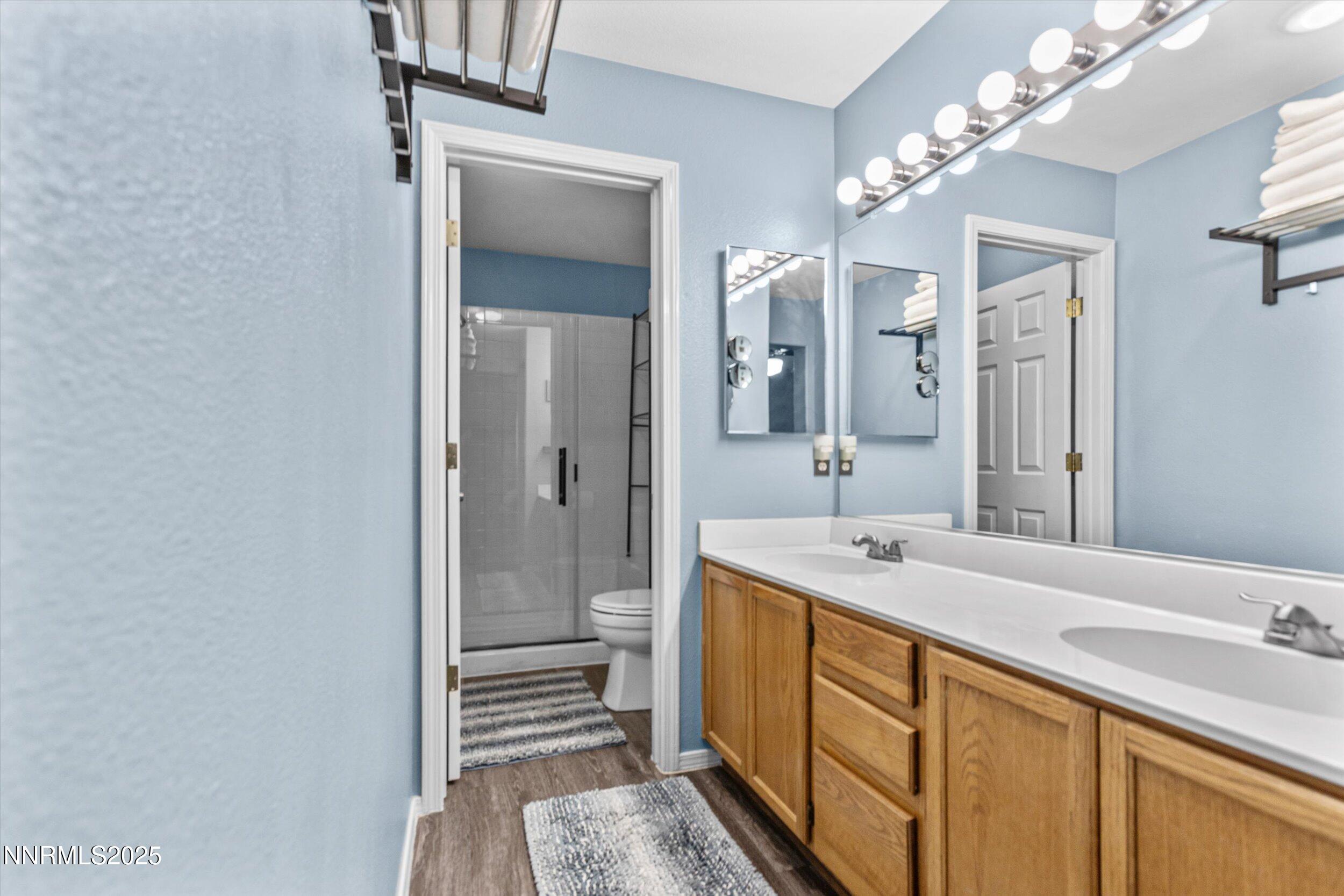 3131 Winter Rose Circle Reno, NV 89502 - Photo 20 of 32 a bathroom with a sink a mirror and a shower