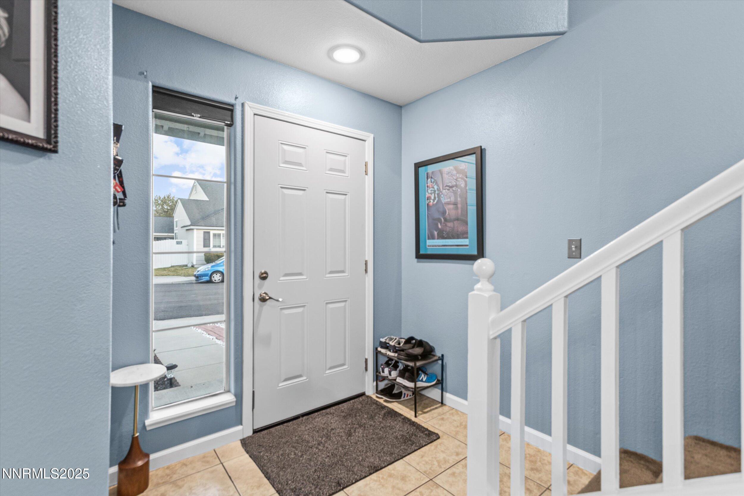 3131 Winter Rose Circle Reno, NV 89502 - Photo 2 of 32 a view of a hallway with wooden floor and a livingroom