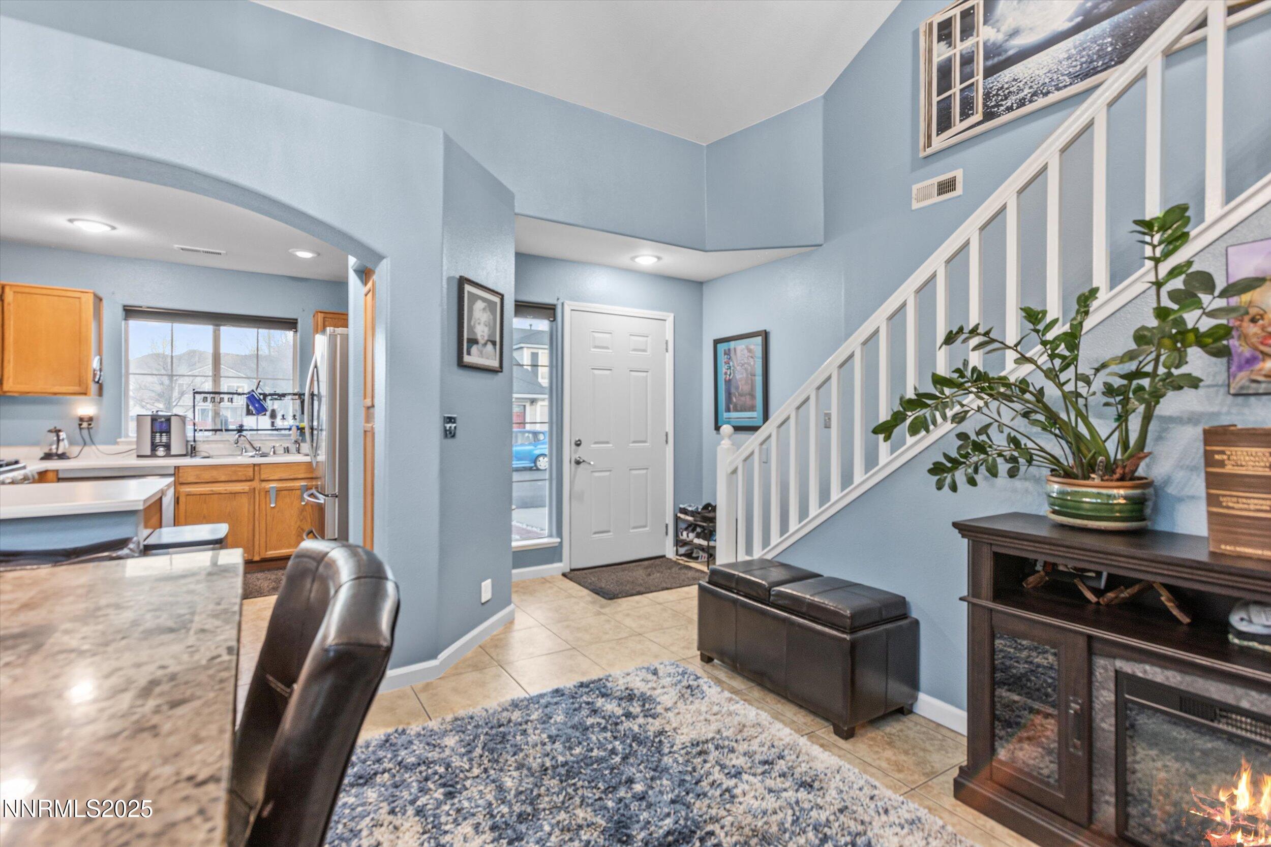 3131 Winter Rose Circle Reno, NV 89502 - Photo 3 of 32 a living room with furniture and a potted plant