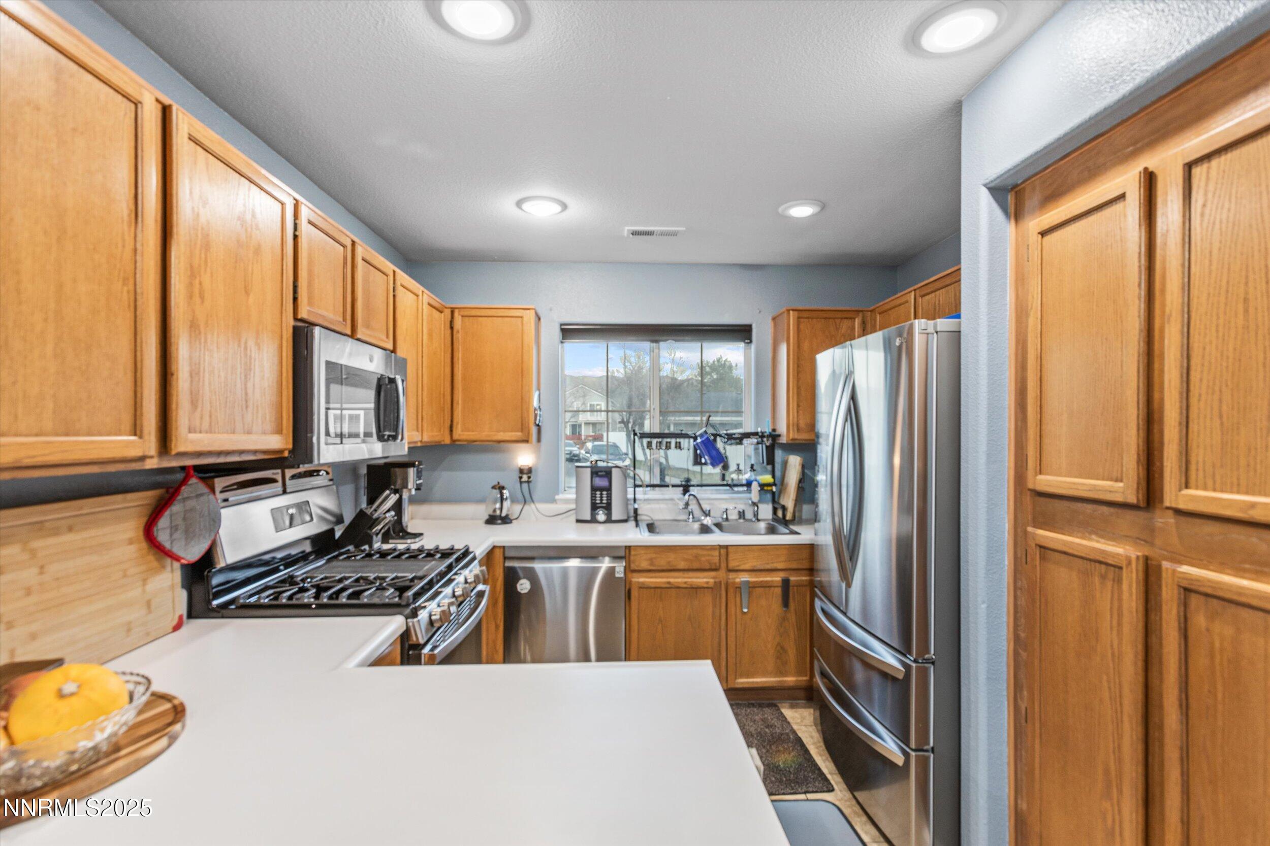 3131 Winter Rose Circle Reno, NV 89502 - Photo 5 of 32 a large kitchen with a large window and a refrigerator