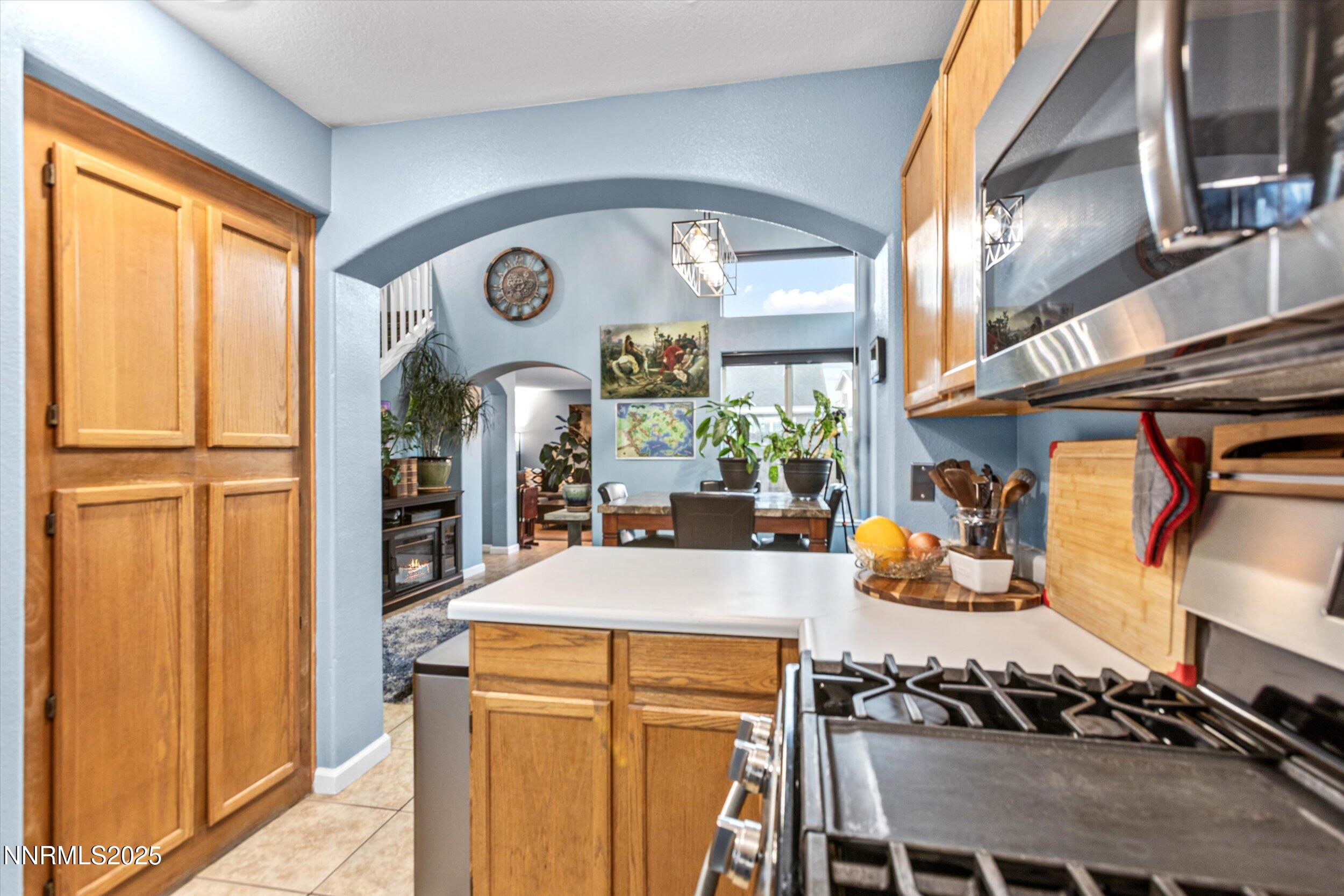 3131 Winter Rose Circle Reno, NV 89502 - Photo 7 of 32 a view of a kitchen with stainless steel appliances granite countertop a stove and a refrigerator