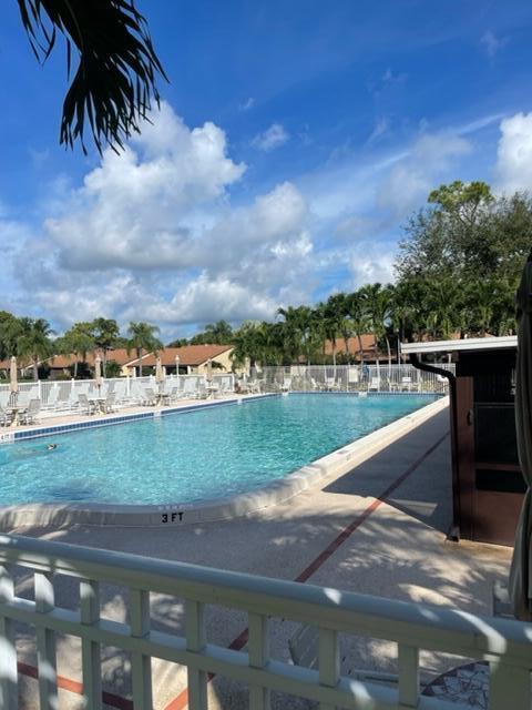 610 Sea Pine Way, Unit A2 Greenacres, FL 33415 - Photo 13 of 13 a view of a lake with a yard