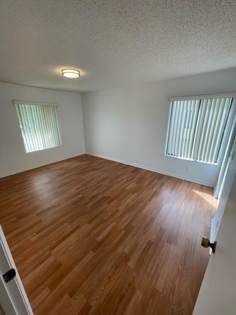 610 Sea Pine Way, Unit A2 Greenacres, FL 33415 - Photo 5 of 13 an empty room with wooden floor and windows