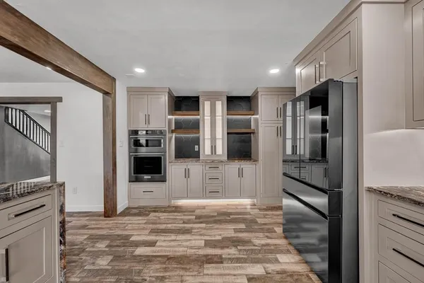a large kitchen with a large counter top appliances and cabinets